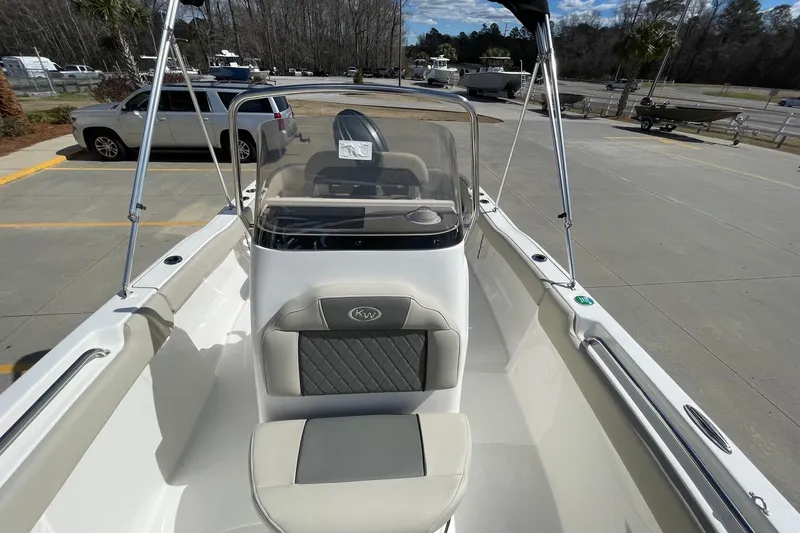 Slide: The Image of 2026 Key West 203 FS boat with sleek seating and console, parked outdoors. - 14