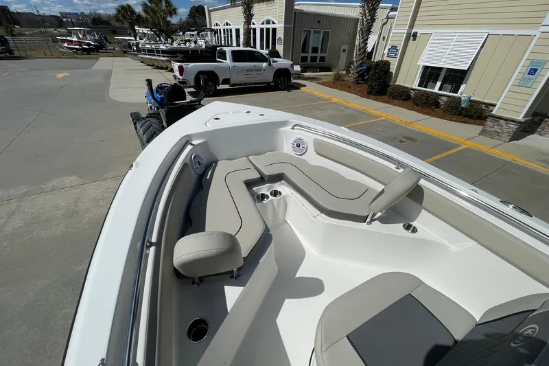 Slide: The Image of 2026 Key West 203 FS boat with spacious seating, parked outdoors near a building. - 16