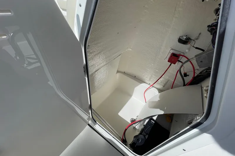 Slide: The Image of Interior view of 2026 Key West 203 FS boat compartment with wiring and battery. - 20