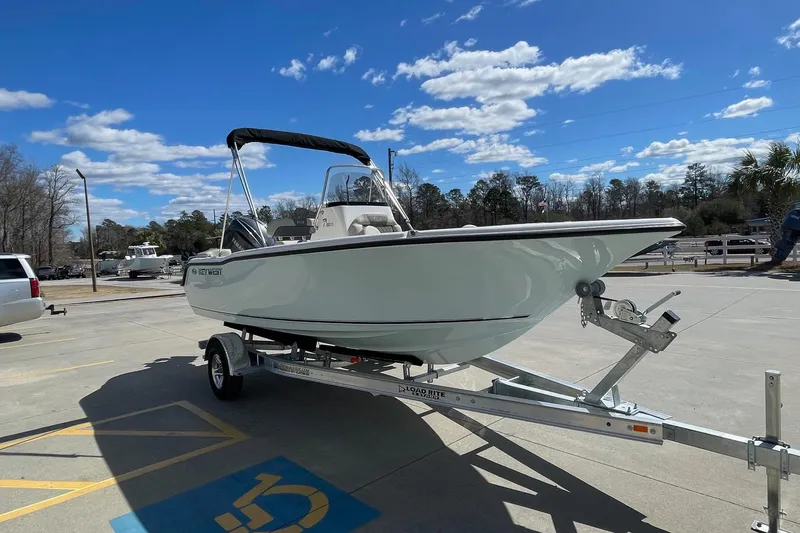 Slide: The Image of 2026 Key West 203 FS boat on trailer under blue sky. - 3