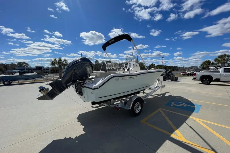 Slide: The Image of 2026 Key West 203 FS boat on trailer under blue sky. - 5