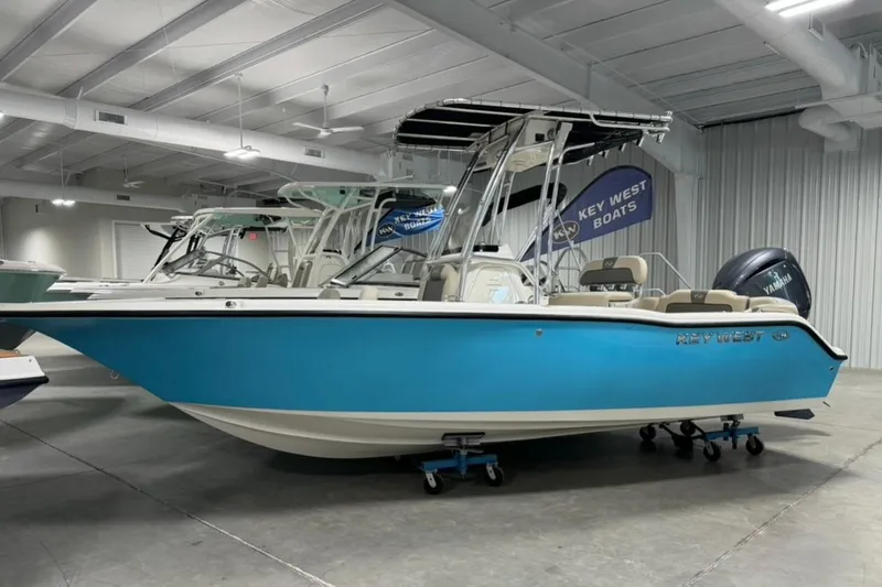 The Image of 2026 Key West 203 FS boat in showroom, vibrant blue hull, modern design. - 1