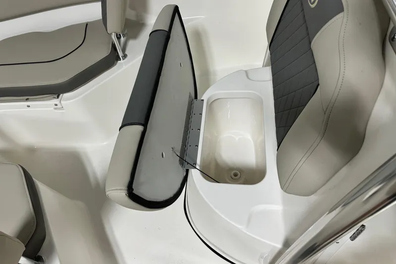 Slide: The Image of 2026 Key West 203 FS boat interior with open storage compartment and cushioned seating. - 11