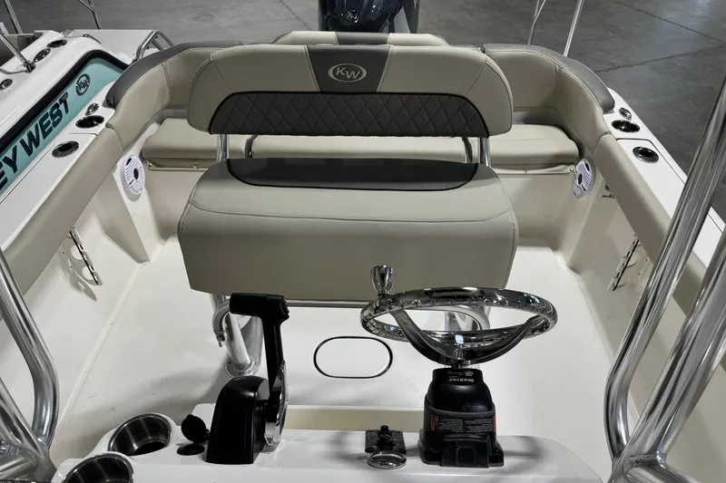 Slide: The Image of 2026 Key West 203 FS boat interior with steering wheel and seating. - 12