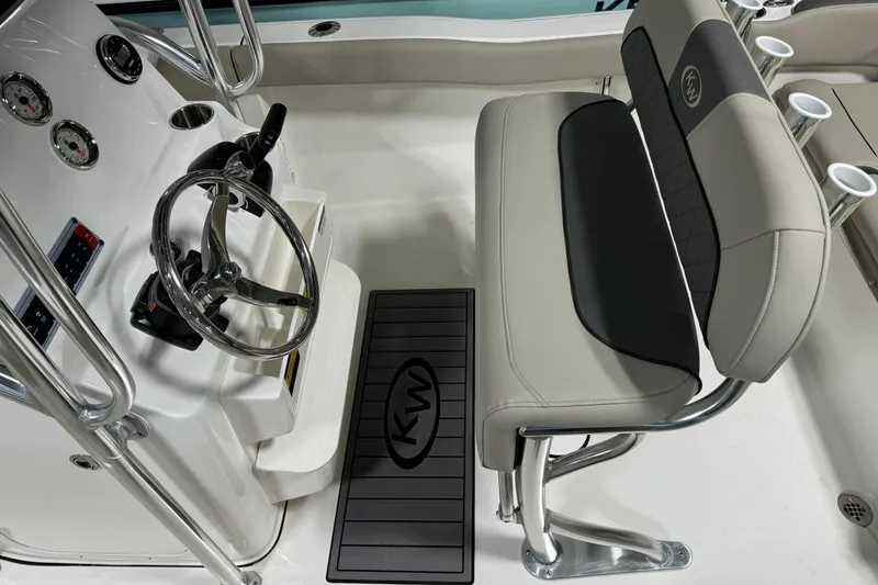 Slide: The Image of Interior of 2026 Key West 203 FS boat, featuring steering wheel and seating. - 14