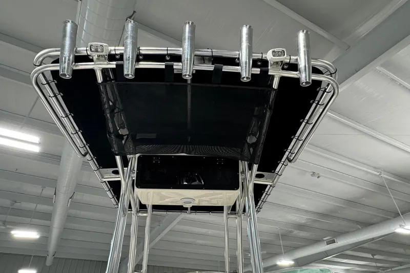 Slide: The Image of 2026 Key West 203 FS boat T-top with rod holders in a showroom. - 20