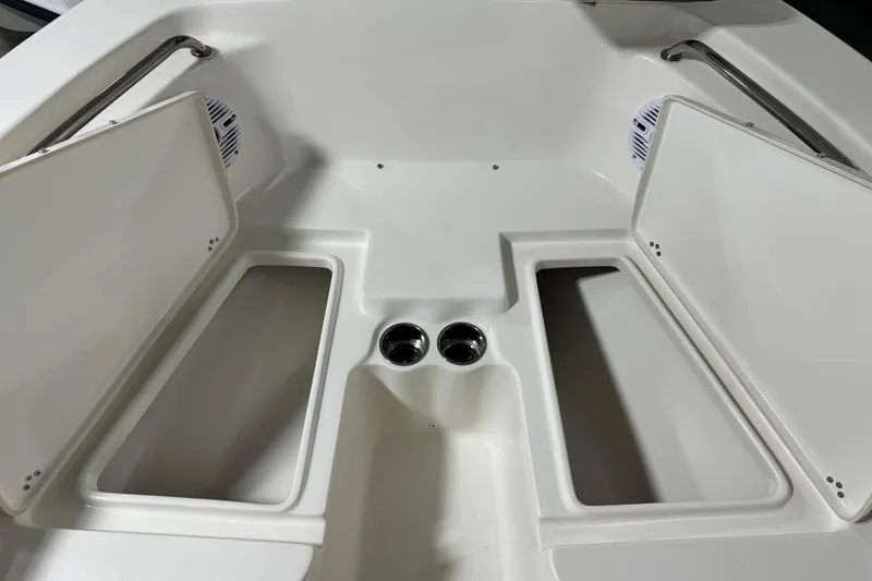 Slide: The Image of 2026 Key West 203 FS boat interior with open storage compartments and cup holders. - 7