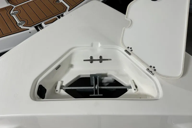 Slide: The Image of Anchor storage compartment on 2026 Key West 203 FS boat, open lid, white interior. - 8