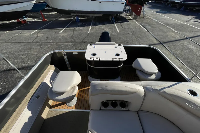 Slide: The Image of 2013 Sylvan Mirage Cruise 8520 CR boat interior with seating and table setup. - 6