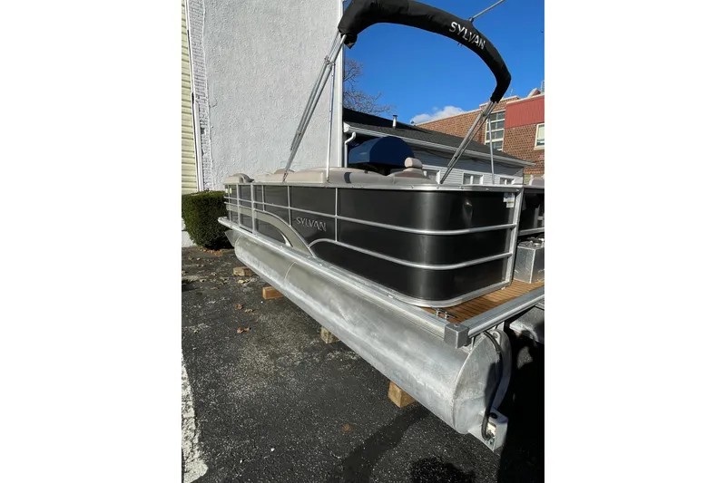 Slide: The Image of 2013 Sylvan Mirage Cruise 8520 CR pontoon boat parked outdoors. - 8