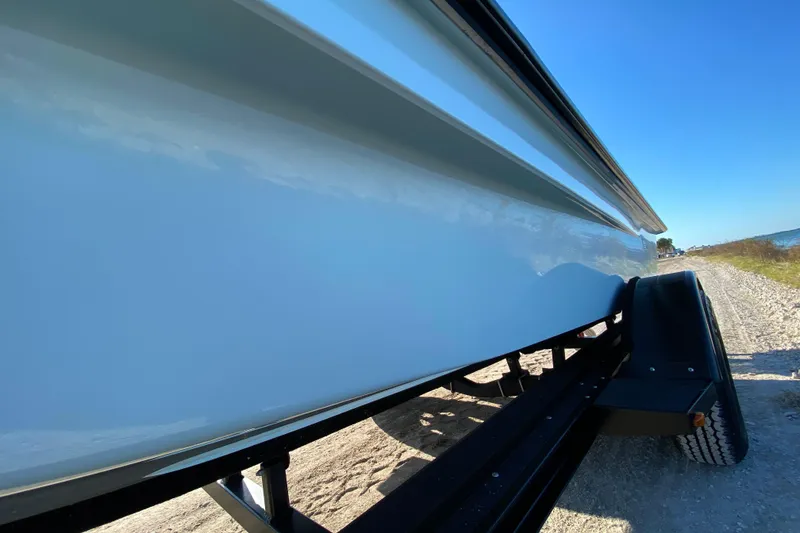 Slide: The Image of 2024 East Cape EVO 18V boat on trailer, side view under clear blue sky. - 10
