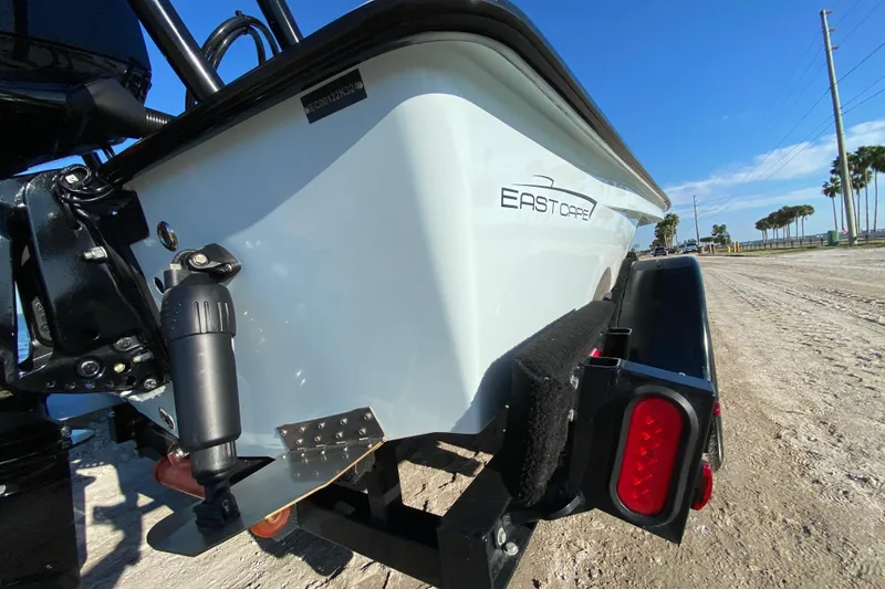 Slide: The Image of 2024 East Cape EVO 18V boat on trailer, showcasing rear design and logo. - 15