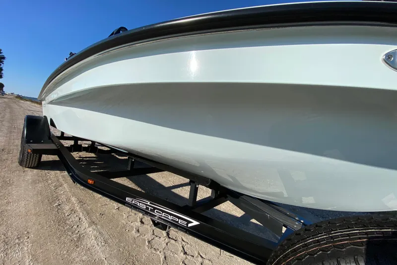 Slide: The Image of 2024 East Cape EVO 18V boat on trailer, showcasing sleek hull design. - 17