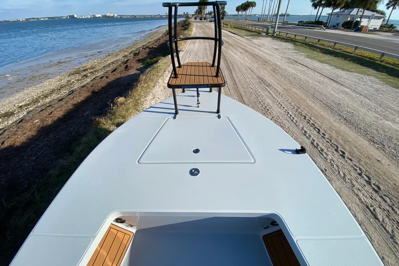 Slide: The Image of 2024 East Cape EVO 18V boat on coastal road with scenic ocean view. - 22