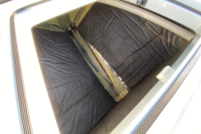 Slide: The Image of 2024 East Cape EVO 18V storage compartment with black interior lining. - 29