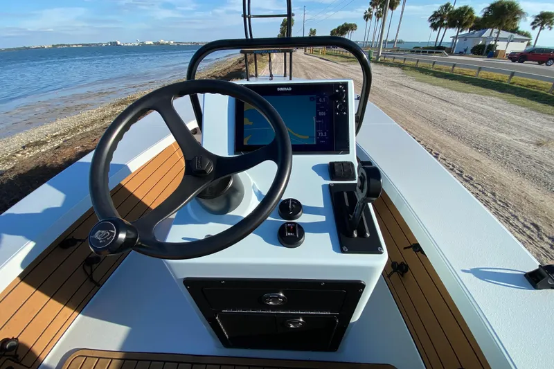 Slide: The Image of 2024 East Cape EVO 18V boat console with steering wheel and navigation display. - 38