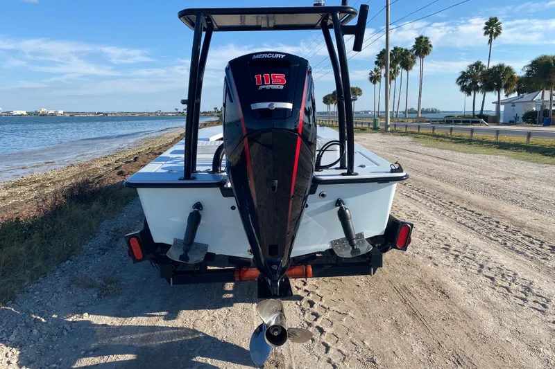 Slide: The Image of 2024 East Cape EVO 18V boat with Mercury 115 Pro XS engine by the shoreline. - 4