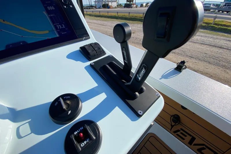 Slide: The Image of 2024 East Cape EVO 18V boat controls with throttle, ignition, and navigation display. - 41