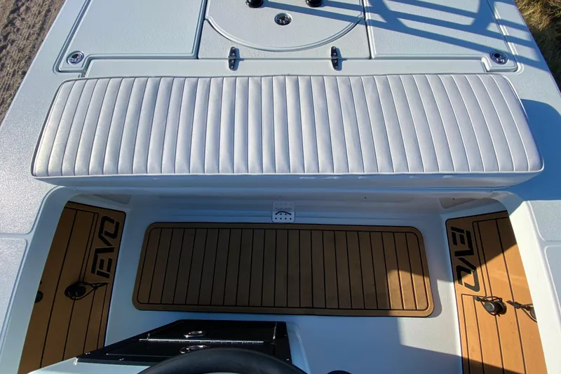 Slide: The Image of 2024 East Cape EVO 18V boat interior with cushioned seating and teak flooring. - 46