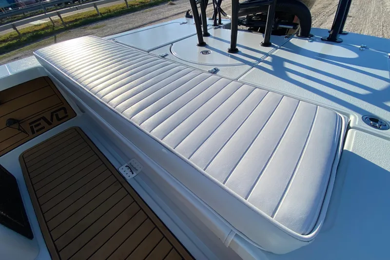 Slide: The Image of 2024 East Cape EVO 18V boat with cushioned seating and teak-style flooring. - 50
