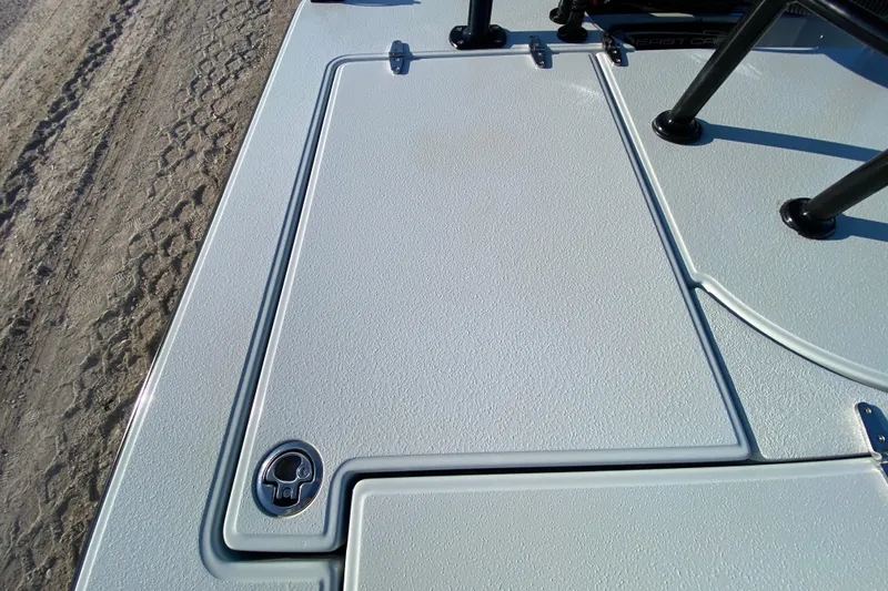 Slide: The Image of 2024 East Cape EVO 18V boat deck with textured surface and latch detail. - 51