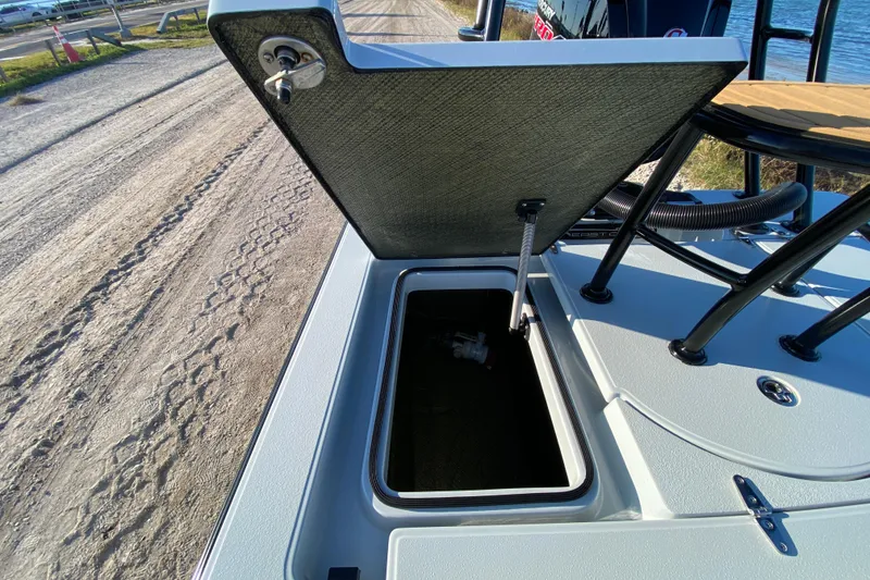 Slide: The Image of 2024 East Cape EVO 18V boat storage compartment open, showing interior details. - 52