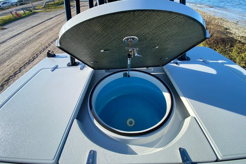 Slide: The Image of 2024 East Cape EVO 18V boat with open storage compartment by the water. - 55