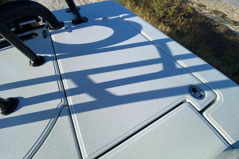 Slide: The Image of 2024 East Cape EVO 18V boat deck with textured surface and shadow patterns. - 57