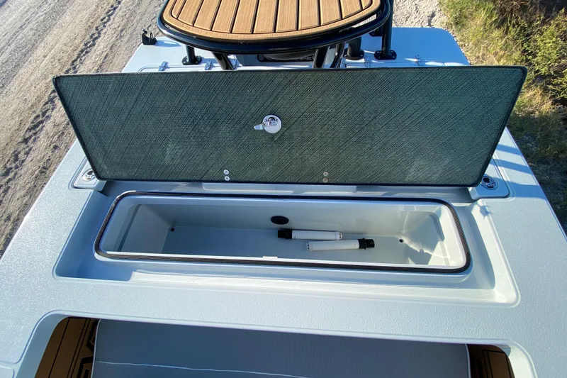 Slide: The Image of 2024 East Cape EVO 18V boat storage compartment with open lid, showcasing interior space. - 60