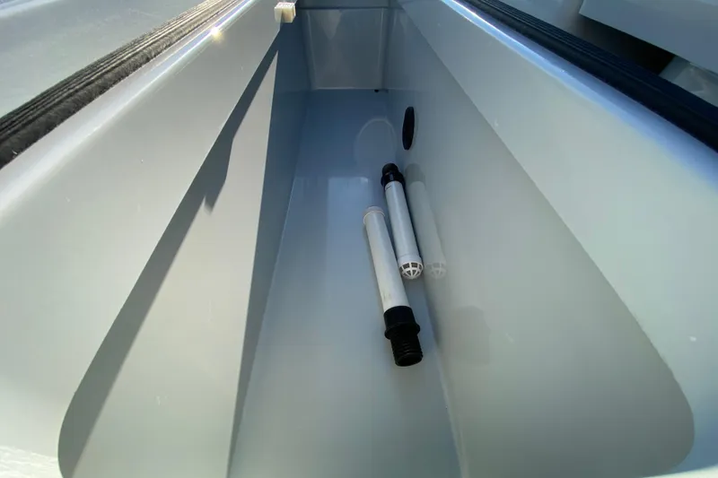 Slide: The Image of 2024 East Cape EVO 18V storage compartment with pipes inside. - 61