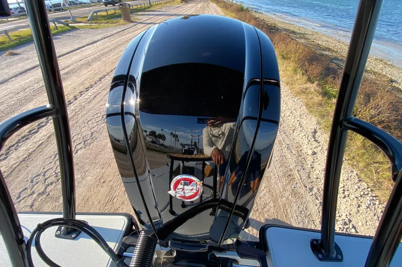 Slide: The Image of 2024 East Cape EVO 18V boat engine by the shoreline, reflecting surroundings. - 64