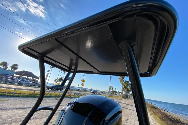 Slide: The Image of 2024 East Cape EVO 18V boat with T-top, coastal road and ocean view. - 65