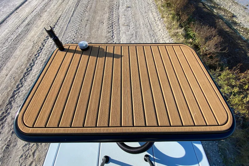 Slide: The Image of 2024 East Cape EVO 18V boat deck with rod holder, wooden finish. - 66