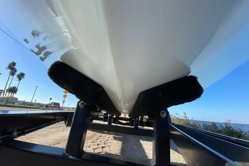 Slide: The Image of Underneath view of 2024 East Cape EVO 18V boat on trailer, clear sky background. - 9