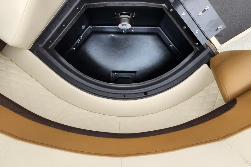 Slide: The Image of 2026 Lowe SF 212 Sport Fish boat storage compartment with beige and brown seating. - 12