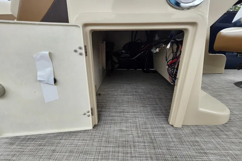 Slide: The Image of Open storage compartment on 2026 Lowe SF 212 Sport Fish boat, showing interior wiring. - 22
