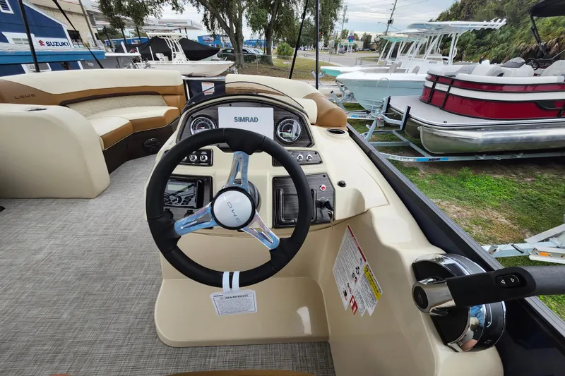 Slide: The Image of 2026 Lowe SF 212 Sport Fish boat interior with steering wheel and control panel. - 24