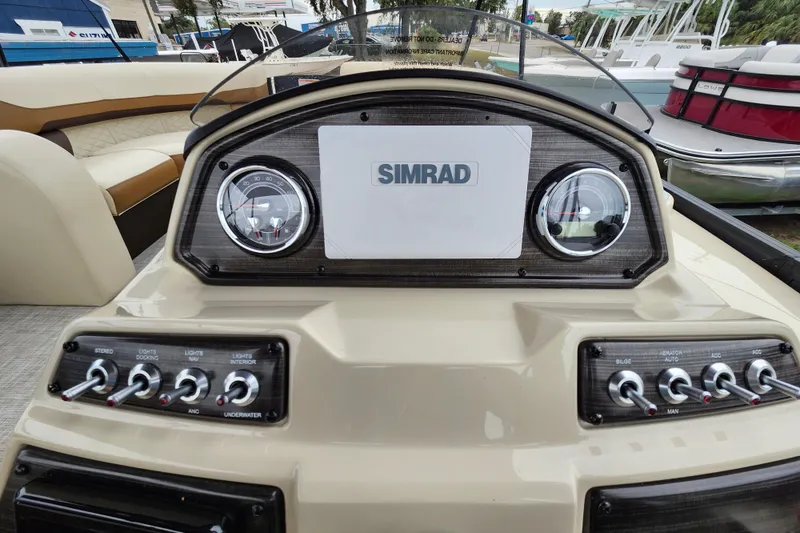 Slide: The Image of 2026 Lowe SF 212 Sport Fish dashboard with Simrad display and control switches. - 25
