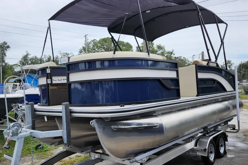Slide: The Image of 2026 Lowe SF 212 Sport Fish pontoon boat with canopy on trailer. - 3