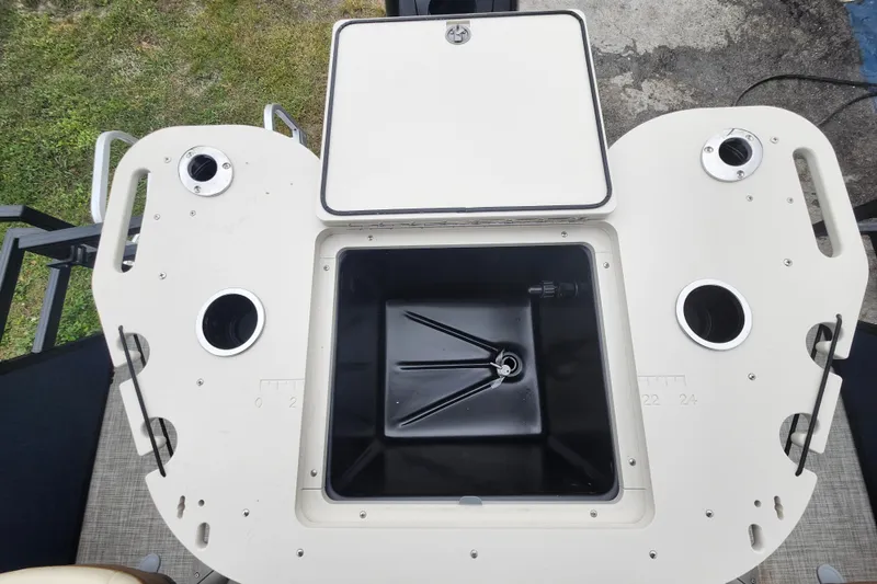 Slide: The Image of 2026 Lowe SF 212 Sport Fish boat with open storage compartment and cup holders. - 30