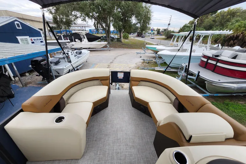 Slide: The Image of 2026 Lowe SF 212 Sport Fish boat interior with beige seating and cup holders. - 8