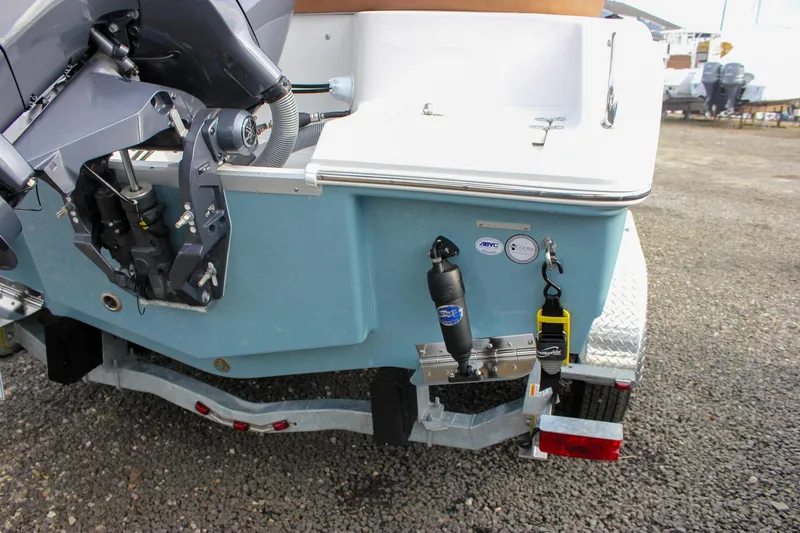 Slide: The Image of 2026 Sea Hunt Ultra 219 boat rear view with motor and trailer. - 10