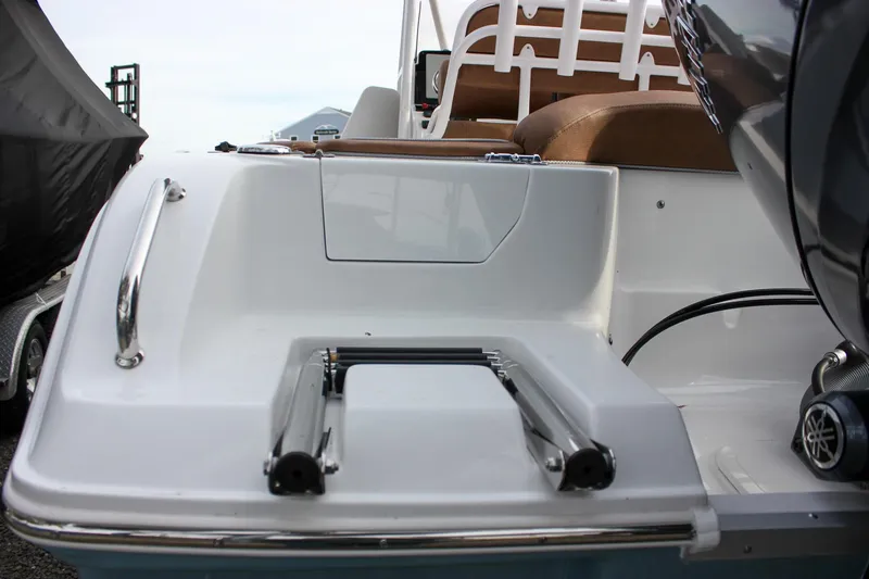Slide: The Image of 2026 Sea Hunt Ultra 219 boat stern with ladder and seating area. - 14