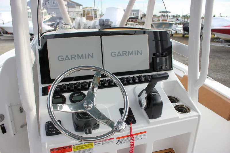 Slide: The Image of 2026 Sea Hunt Ultra 219 boat dashboard with Garmin navigation system and steering wheel. - 18