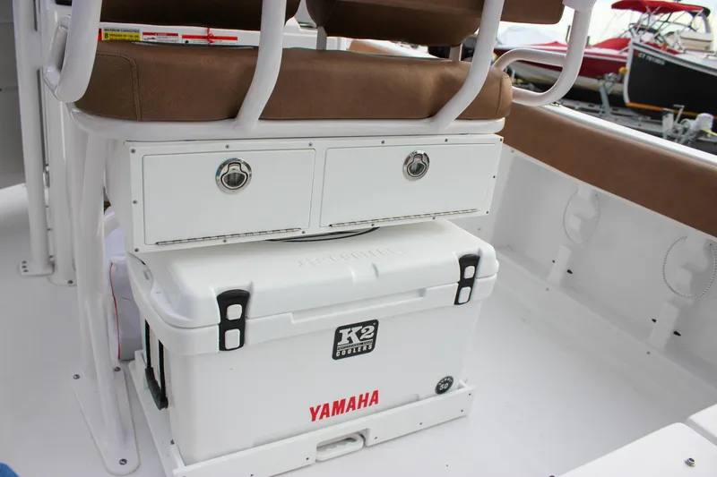 Slide: The Image of 2026 Sea Hunt Ultra 219 boat interior with storage drawers and Yamaha cooler. - 2