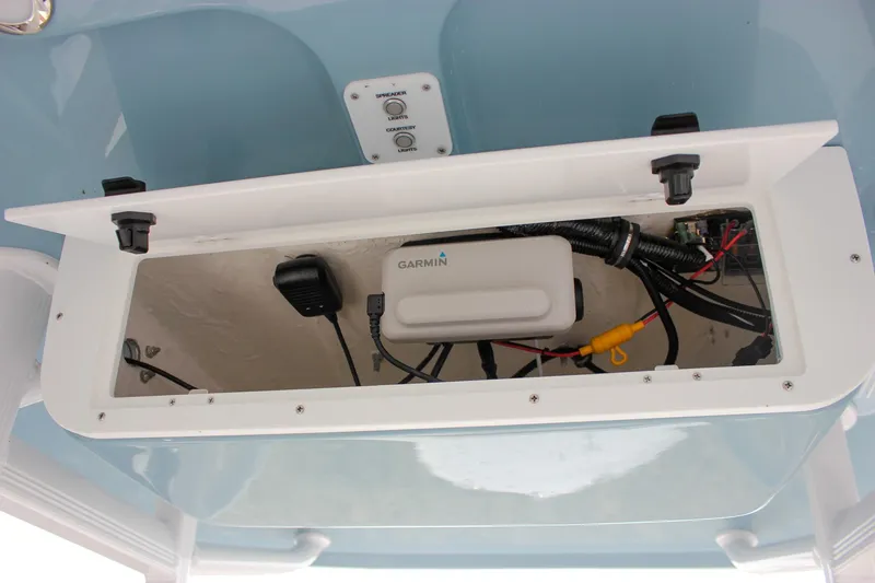 Slide: The Image of 2026 Sea Hunt Ultra 219 electronics compartment with Garmin device and wiring. - 21