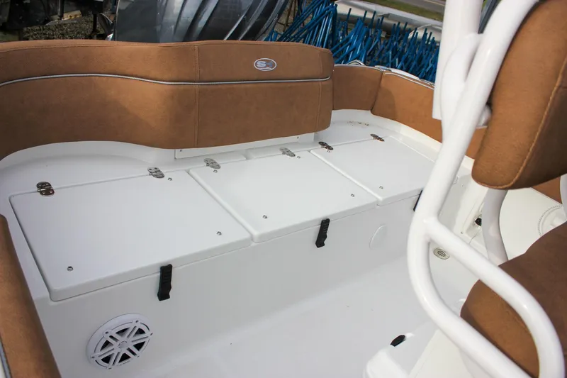 Slide: The Image of 2026 Sea Hunt Ultra 219 boat interior with cushioned seating and storage compartments. - 25