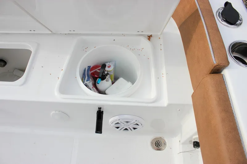 Slide: The Image of Interior of 2026 Sea Hunt Ultra 219 boat with storage compartment and seating. - 27