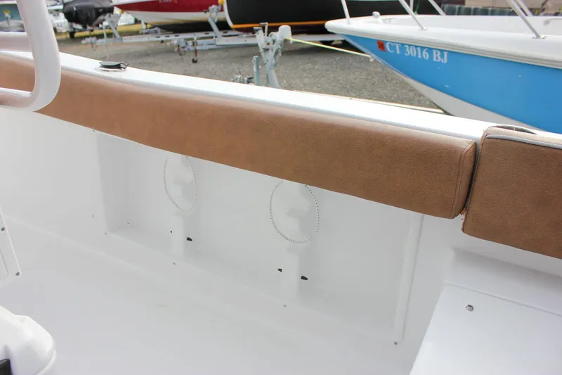 Slide: The Image of 2026 Sea Hunt Ultra 219 boat interior with brown cushioned seating. - 29