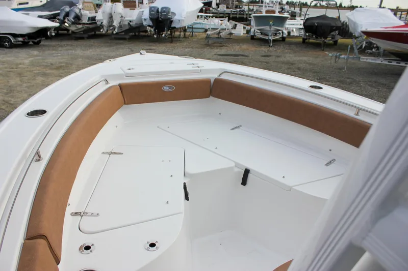 Slide: The Image of 2026 Sea Hunt Ultra 219 boat interior with cushioned seating and storage compartments. - 37